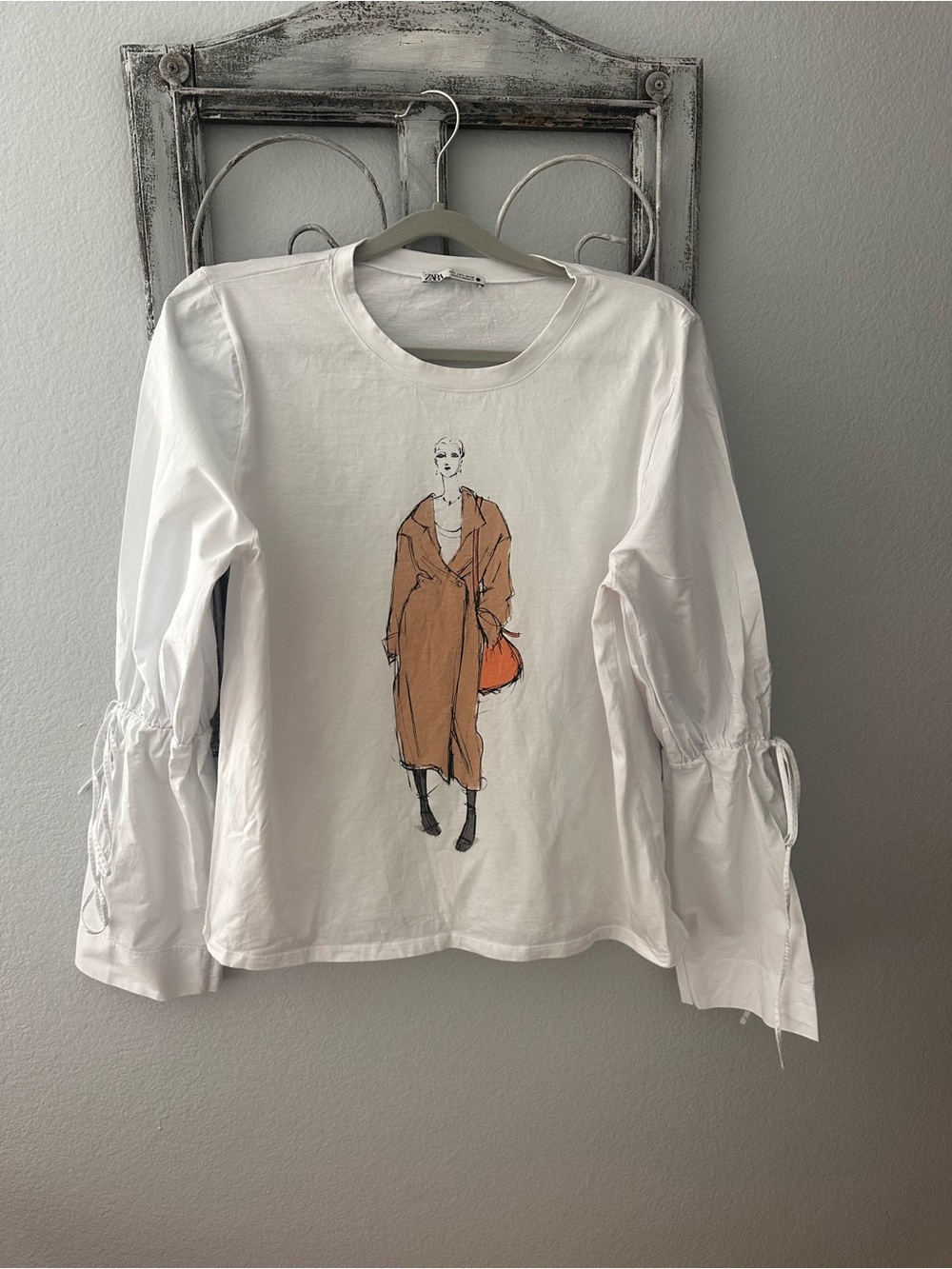 Zara White Long-Sleeve Tee with Brown Coat Illustration